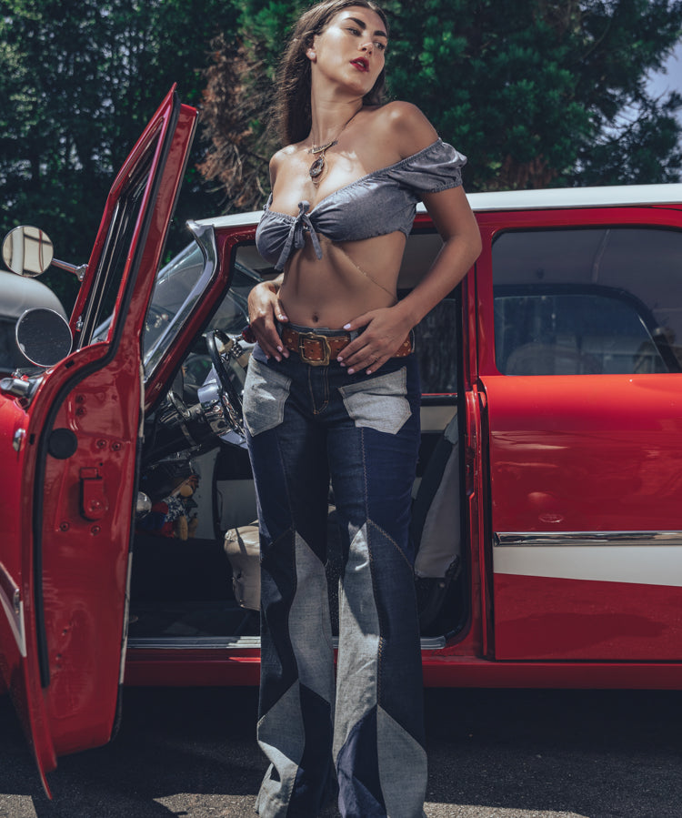 Soul Sisters Bridget Bardot crop top  and flower power skirt on model in front of retro hot rod