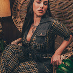 Knit plaid diva jumpsuit with contrasting denim front pockets, collar, and belt, blending retro 70's charm with bold, modern flair.