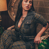 Knit plaid diva jumpsuit with contrasting denim front pockets, collar, and belt, blending retro 70's charm with bold, modern flair.