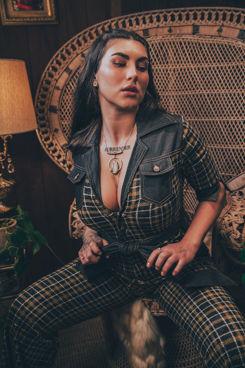 Knit plaid diva jumpsuit with contrasting denim front pockets, collar, and belt, blending retro 70's charm with bold, modern flair.