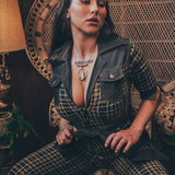 Knit plaid diva jumpsuit with contrasting denim front pockets, collar, and belt, blending retro 70's charm with bold, modern flair.