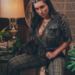 Knit plaid diva jumpsuit with contrasting denim front pockets, collar, and belt, blending retro 70's charm with bold, modern flair.