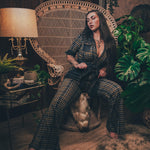 Knit plaid diva jumpsuit with contrasting denim front pockets, collar, and belt, blending retro 70's charm with bold, modern flair.
