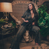 Knit plaid diva jumpsuit with contrasting denim front pockets, collar, and belt, blending retro 70's charm with bold, modern flair.