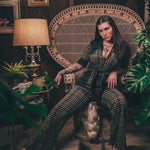 Knit plaid diva jumpsuit with contrasting denim front pockets, collar, and belt, blending retro 70's charm with bold, modern flair.