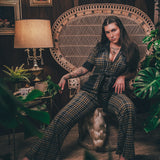 Knit plaid diva jumpsuit with contrasting denim front pockets, collar, and belt, blending retro 70's charm with bold, modern flair.