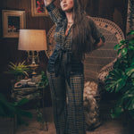 Knit plaid diva jumpsuit with contrasting denim front pockets, collar, and belt, blending retro 70's charm with bold, modern flair.