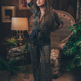Knit plaid diva jumpsuit with contrasting denim front pockets, collar, and belt, blending retro 70's charm with bold, modern flair.