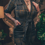 Knit plaid diva jumpsuit with contrasting denim front pockets, collar, and belt, blending retro 70's charm with bold, modern flair.