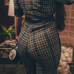 Knit plaid diva jumpsuit with contrasting denim front pockets, collar, and belt, blending retro 70's charm with bold, modern flair.
