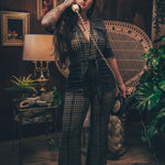 Knit plaid diva jumpsuit with contrasting denim front pockets, collar, and belt, blending retro 70's charm with bold, modern flair.