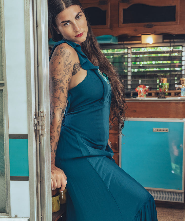 long flowy teal boho maxi dress with open back and ruffle details