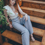 Woman sitting on wooden steps outdoors