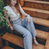Woman sitting on wooden steps outdoors