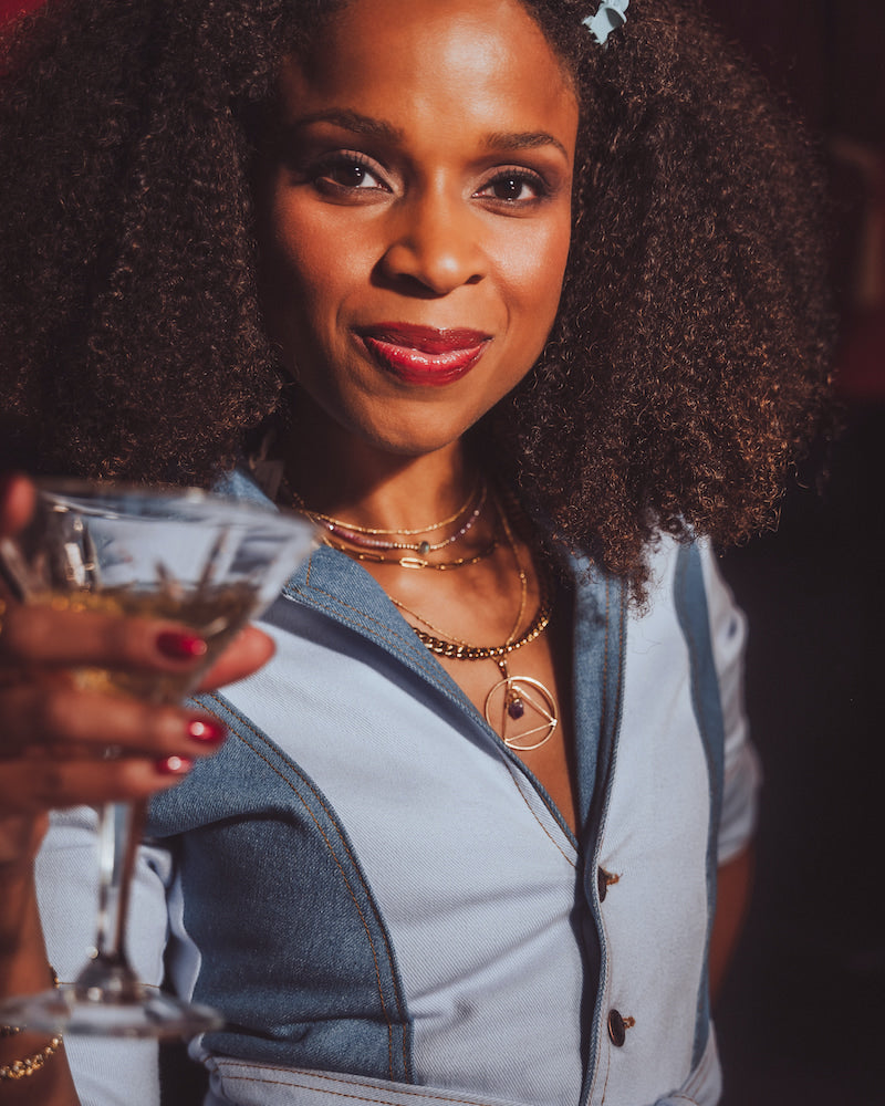 Woman holding a cocktail glass with a blurred background
