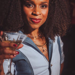 Woman holding a cocktail glass with a blurred background