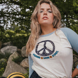 Woman wearing a peace symbol shirt with text outdoors wearing Soul Sister since 1969