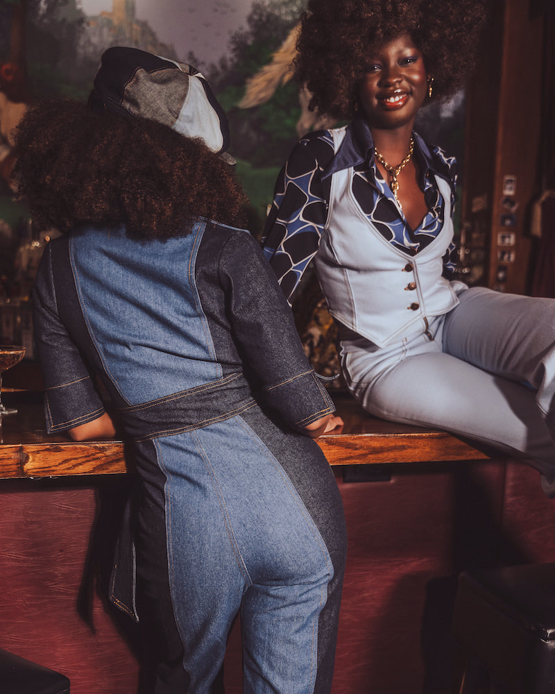 woman wearing a 70s inspired flared denim jumpsuit by Soul Sister since 1969