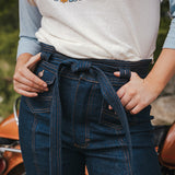 Person wearing a t-shirt with a peace symbol and 'Peace Love Soul' text, standing next to a motorcycle wearing Soul Sister since 1969..