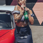 Soul Sisters Bridget Bardot crop top  and flower power skirt on model in front of retro hot rod