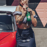 Soul Sisters Bridget Bardot crop top  and flower power skirt on model in front of retro hot rod
