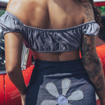 Soul Sisters Bridget Bardot crop top  and flower power skirt on model in front of red hot rod