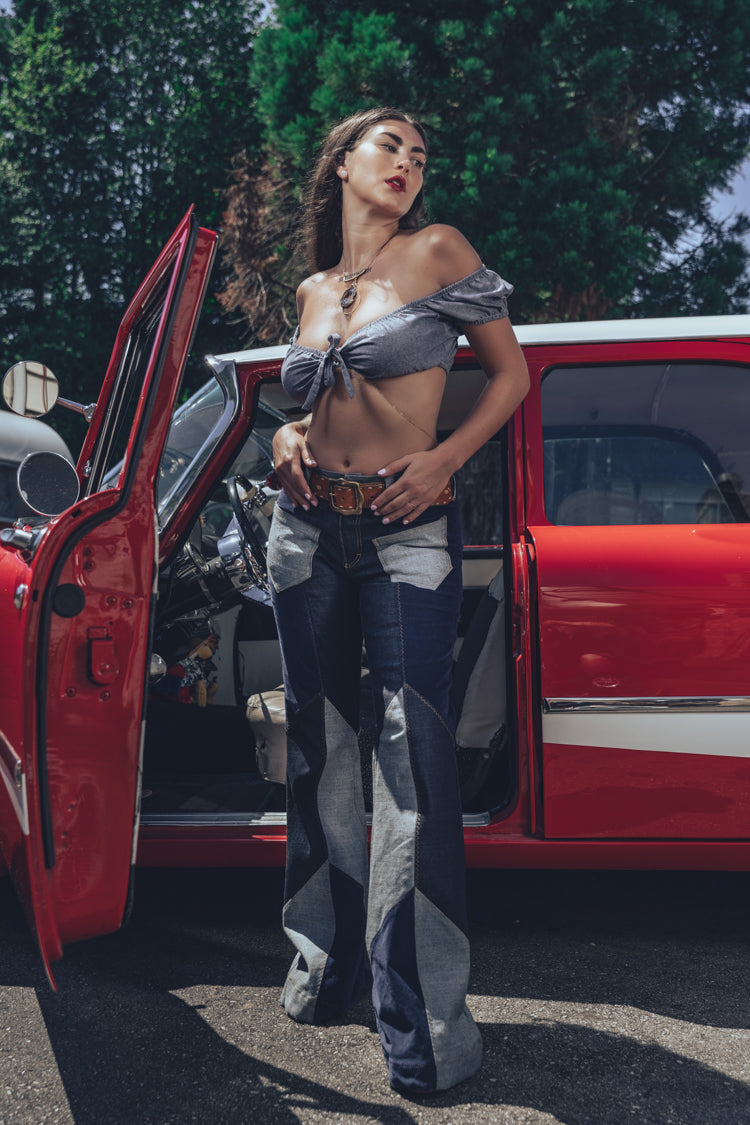 Soul Sisters Bridget Bardot crop top  and flower power skirt on model in front of retro hot rod 