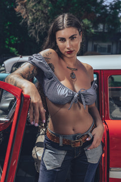 Bridget Bardot crop top on model in front of hot rod