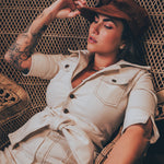 Women's cream stretch corduroy jumpsuit with a fitted waist and 1970s inspired style