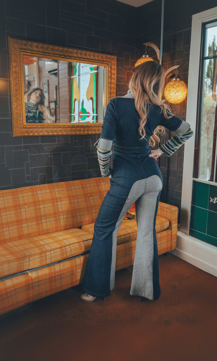 A 2 tone iconic 1970s denim jumpsuit is worn by a Soul Sister muse in a vintage retro living room