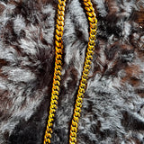 Gold chain necklace on a fur surface