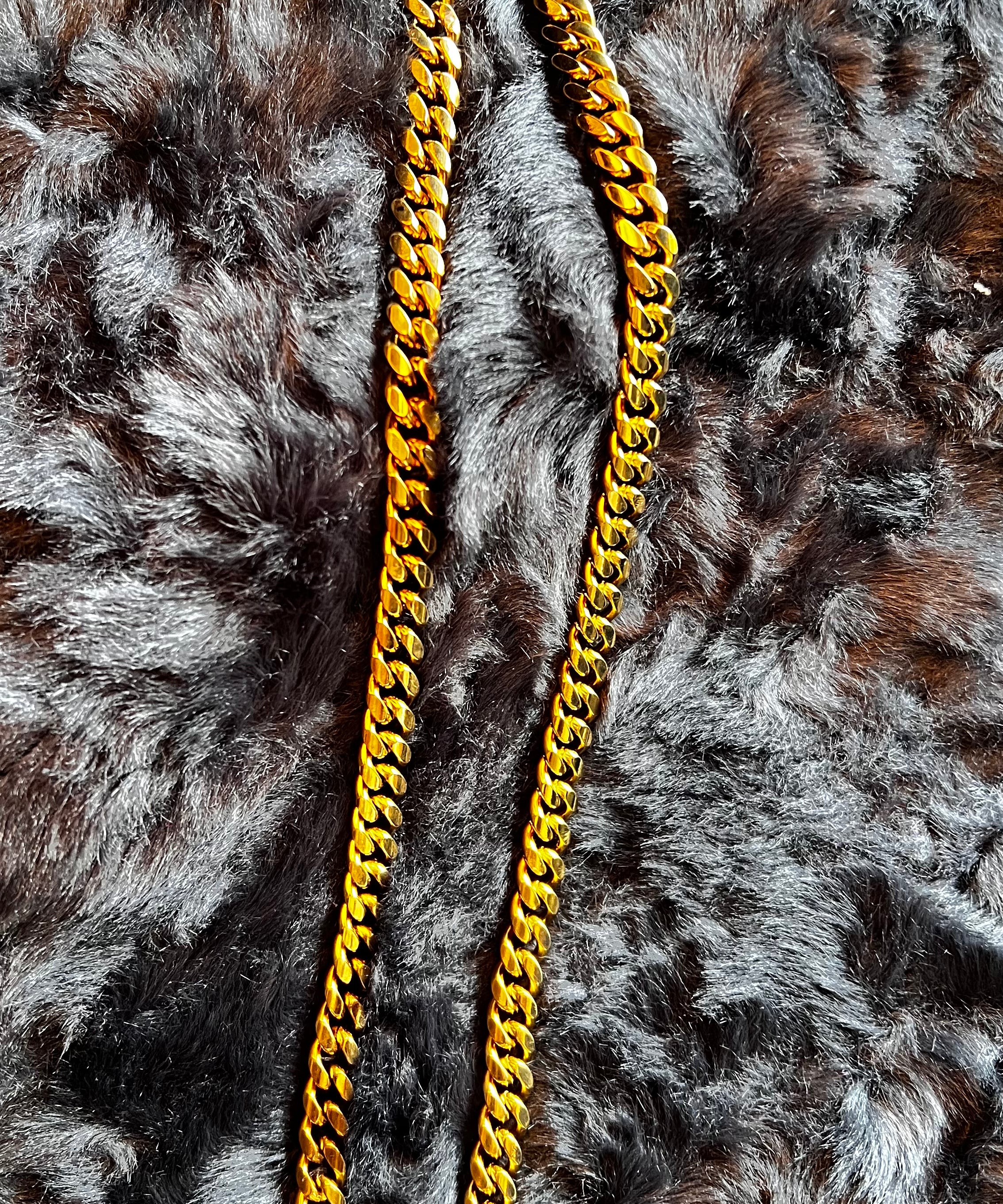 Gold chain necklace on a fur surface