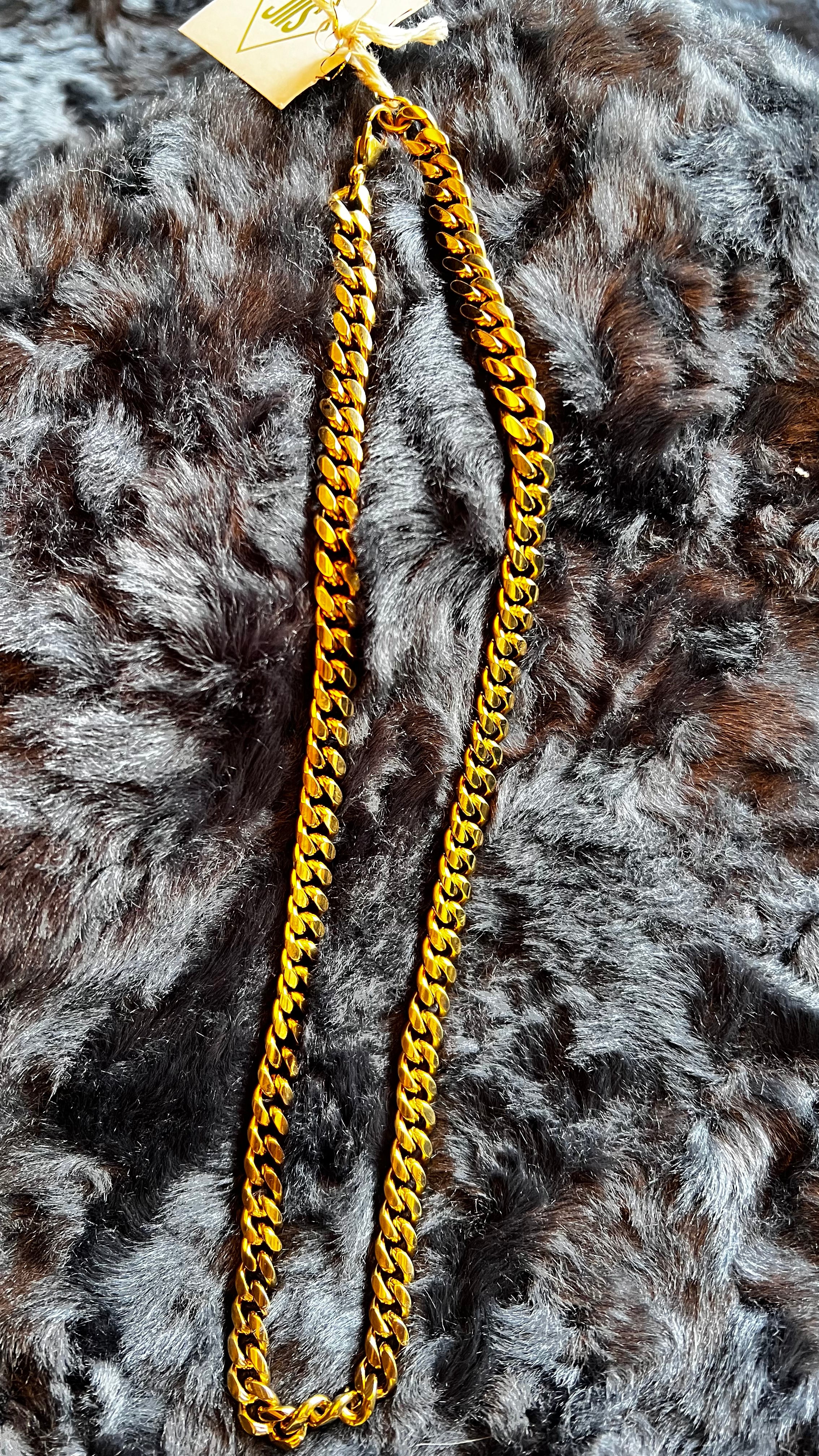 Gold chain necklace on a fur surface