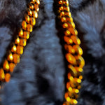 Gold chain necklace on a dark textured surface