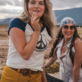 Two women standing outdoors with mountains in the background wearing Soul Sister since 1969