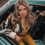Woman sitting in a vintage car with a scenic background wearing soul sister since 1969 wearing soul sister since 1969
