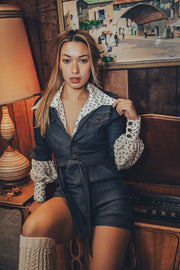 retro fashion moment with a woman in a denim romper next to a spinning record in a cozy vintage home