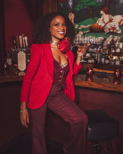 girl in a bar wearing all red suit
