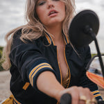 Woman sitting on a motorcycle with a blurred background Soul Sister since 1969  