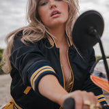 Woman sitting on a motorcycle with a blurred background Soul Sister since 1969  
