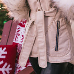 Beige Peny Lane vintage 70s  inspired coat with fur worn by a person, Christmas decorations in the backgrounds