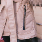 Close-up of a beige Penny Lane, 70s vintage inspired coat with fur trim and a zipper detail.