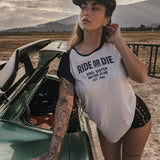 Woman wearing a 'Ride or Die' t-shirt leaning against a car in a desert setting wears clothing by Soul Sister since 1969