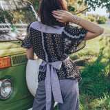 Girl wears floral to with bow at the back