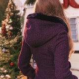 A woman is wearing a warmA woman is wearing a warm cosy knit onesie