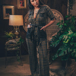 Knit plaid diva jumpsuit with contrasting denim front pockets, collar, and belt, blending retro 70's charm with bold, modern flair.