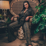 Knit plaid diva jumpsuit with contrasting denim front pockets, collar, and belt, blending retro 70's charm with bold, modern flair.