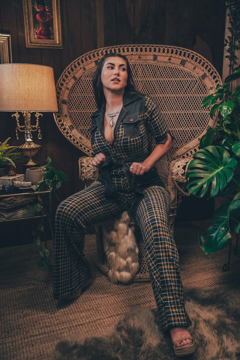 Knit plaid diva jumpsuit with contrasting denim front pockets, collar, and belt, blending retro 70's charm with bold, modern flair.