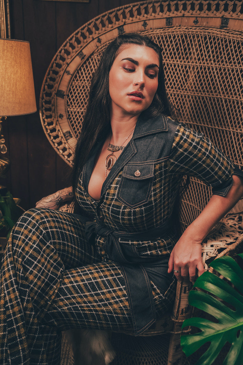 Knit plaid diva jumpsuit with contrasting denim front pockets, collar, and belt, blending retro 70's charm with bold, modern flair.