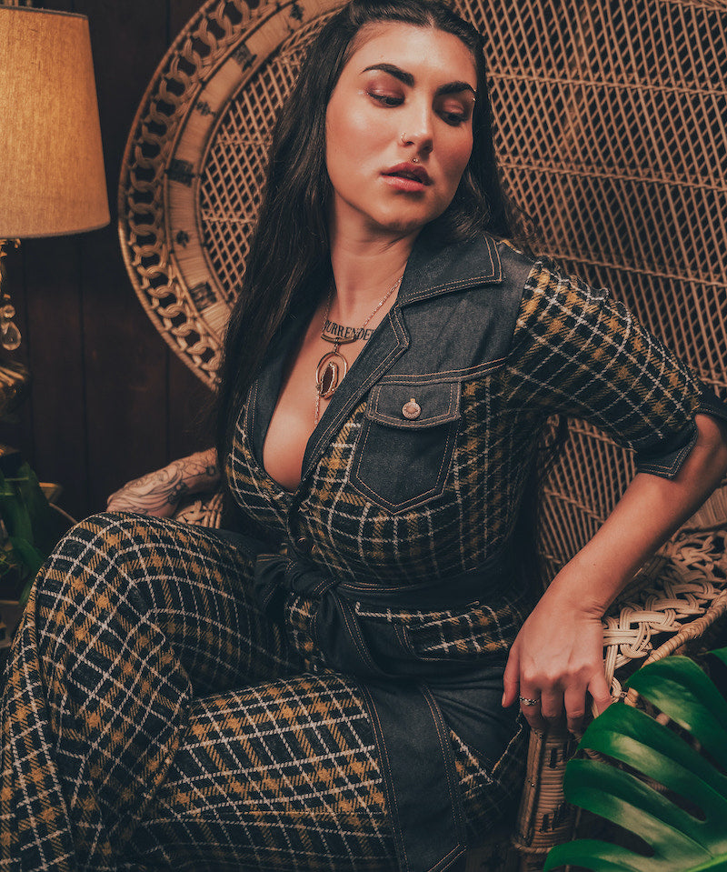 Knit plaid diva jumpsuit with contrasting denim front pockets, collar, and belt, blending retro 70's charm with bold, modern flair.